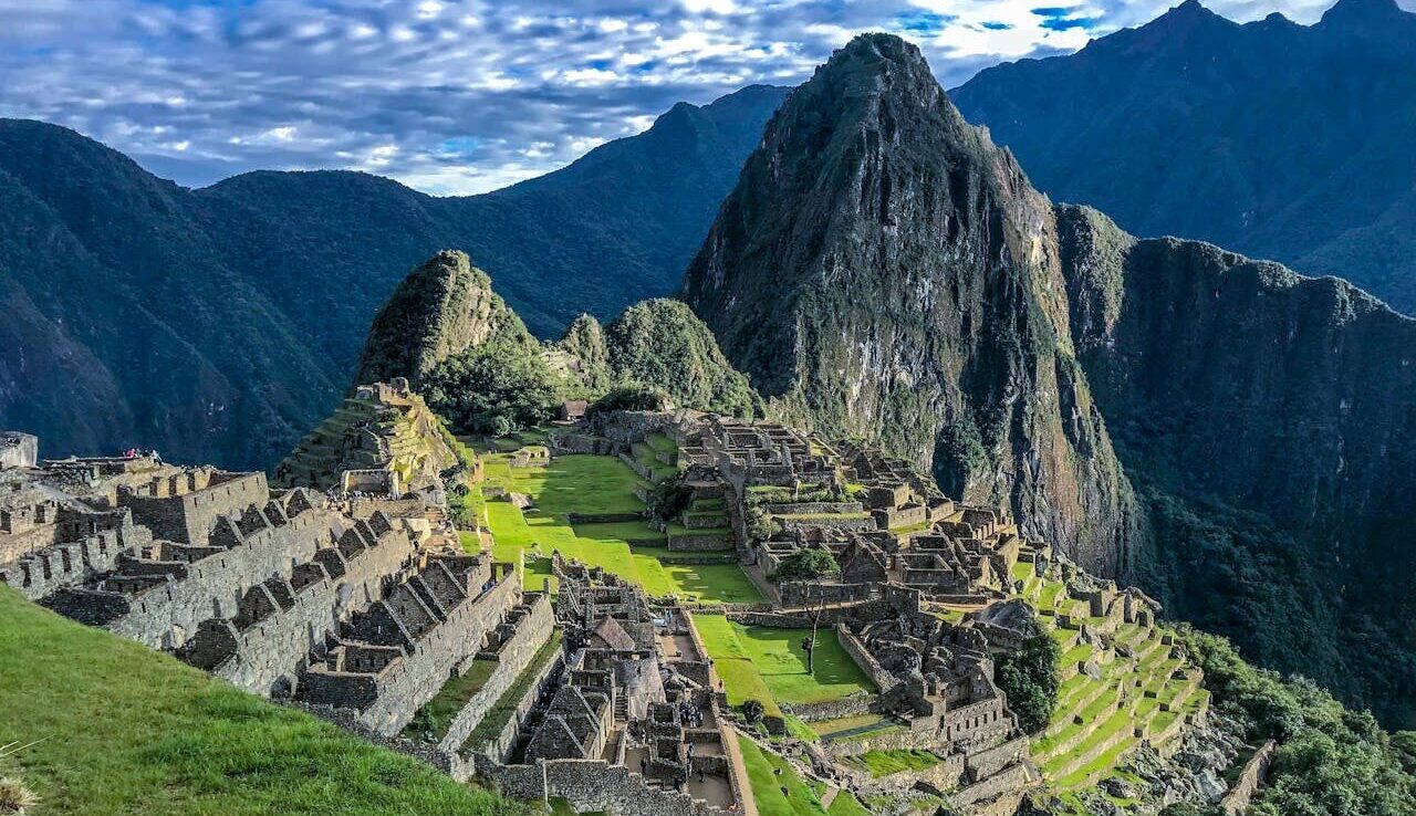 Explore the stunning ancient ruins of Machu Picchu, a UNESCO World Heritage Site in Peru, surrounded by majestic mountains.